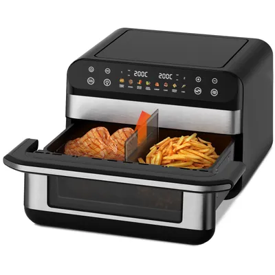 A black and silver air fryer with its drawer pulled out, showing two compartments with food inside.