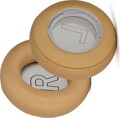 Two tan-colored ear pads for headphones are shown against a white background.