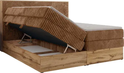 A boxspring bed with its storage compartment open, showing the mattress lifted by hydraulic arms.
