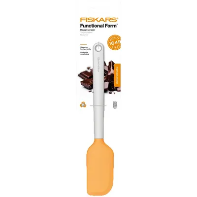 A Fiskars Functional Form dough scraper in its packaging, with an image of chocolate.