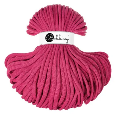 A spool of pink rope on a white background.