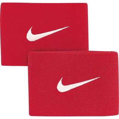 Two red Nike shin guards are shown against a white background.