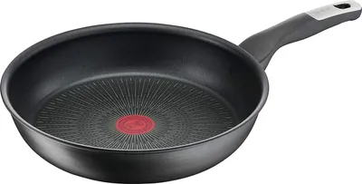 A black frying pan with a red indicator in the center and a gray handle, shown from a slightly elevated side angle against a white background.