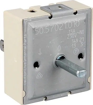 Close-up view of an electrical component, likely a switch or timer, with a metal dial and various markings.