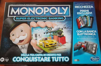 The image shows the front of a Monopoly Super Electronic Banking board game box, with a side panel visible.