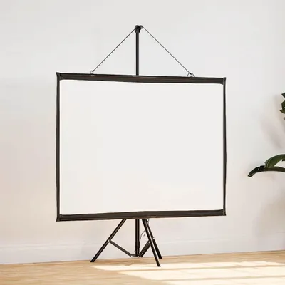 A white projection screen on a black tripod stand, set against a white wall and wooden floor.