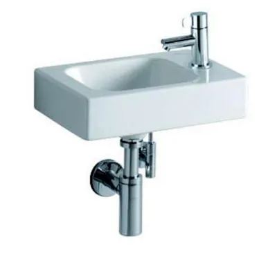 A white ceramic sink with a chrome faucet and drain assembly, shown against a white background.
