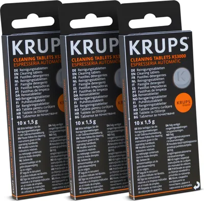 Three boxes of Krups cleaning tablets for espresso machines, displayed in a studio setting.