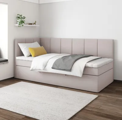 A bedroom setting with a bed and a rug.