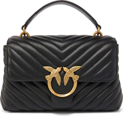 A black quilted handbag with gold bird emblem.