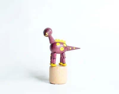 Produktbild von Holzspielzeug Wackelfigur Dinosaurier lila Höhe=9cm NEU