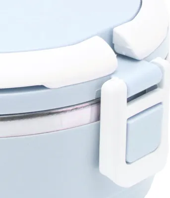 A close-up view of the latch and edge of a light blue lunchbox.