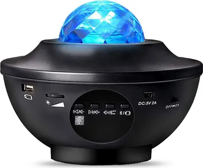 A black star projector with a blue faceted dome on top, showing various control buttons and ports on its base.