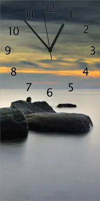 Produktbild von Wallario Design Wanduhr Mystische Felsen im Meer aus Echtglas, Größe 30 x 60 cm
