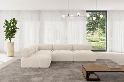 A modern living room with a sectional sofa, coffee table, and large window.
