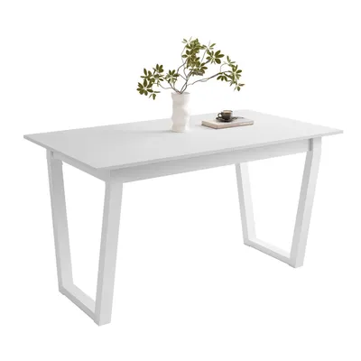 A white dining table with a vase of greenery and a book on top, set against a white background.
