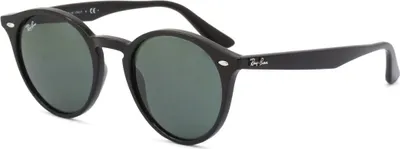 A studio shot of black sunglasses with dark green lenses.