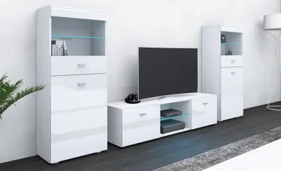 A modern white living room furniture set, including a tall display cabinet, a TV stand with a television, and another tall cabinet.