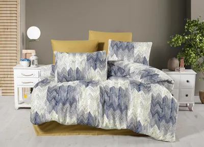 A neatly made bed with a patterned duvet cover and pillows, set against a neutral wall and wooden blinds.