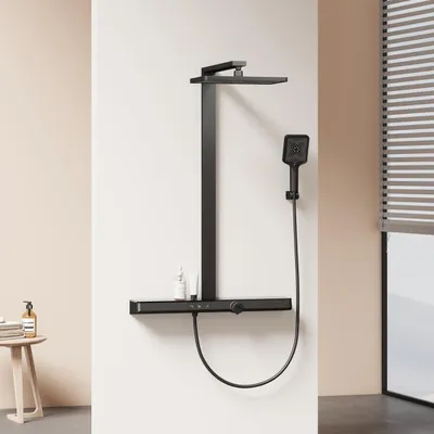 A modern black shower system with a shelf and a handheld showerhead is mounted on a white wall next to a window with blinds.