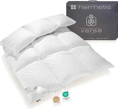 A white down comforter is displayed with its packaging in the background.