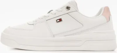 A white Tommy Hilfiger sneaker with a pink accent on the heel, shown from the side against a white background.