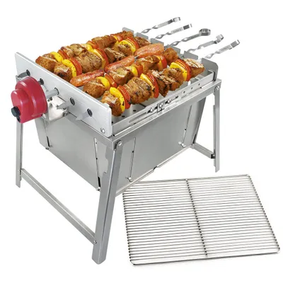 A stainless steel grill with meat and vegetable skewers on it, with an extra grill rack next to it, on a white background.