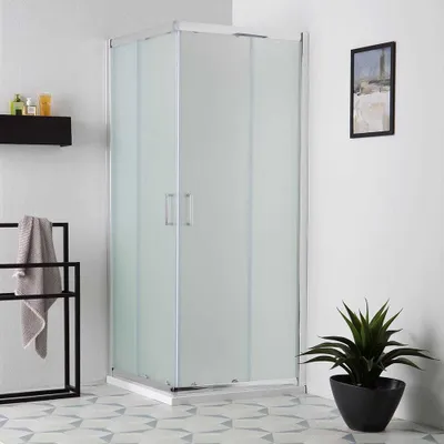 A modern bathroom with a corner shower enclosure.