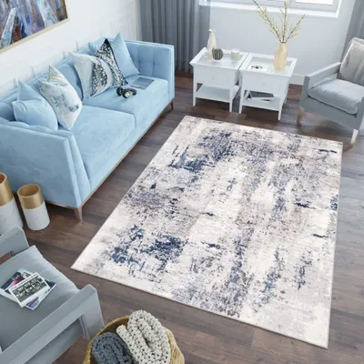 A living room scene with a light blue sofa, a rug, and side tables.