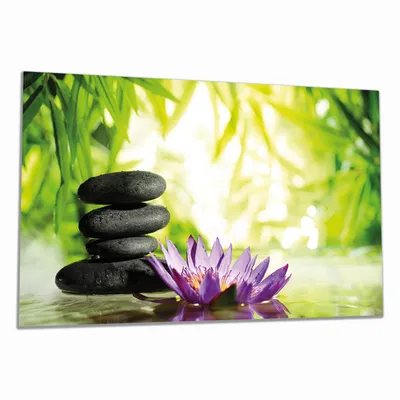 Produktbild von Wallario Herdabdeckplatte aus Glas, Größe 90 x 52 cm 1-teilig, Motiv Steinstapel in schwarz mit Blumenblüte in lila