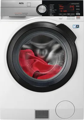 A front view of a white AEG washing machine with a red towel inside the drum.