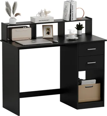 A black desk with a monitor riser, laptop, decorative items, and drawers.