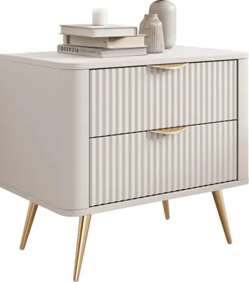 A beige nightstand with two drawers and gold metal legs, decorated with books and vases on top.