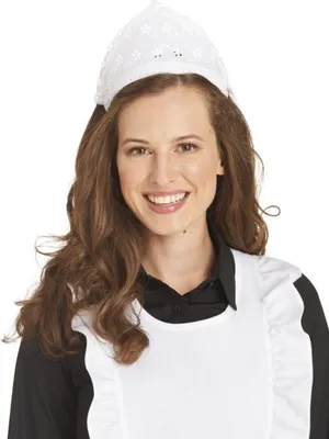 A woman wearing a white hat and apron over a black shirt.