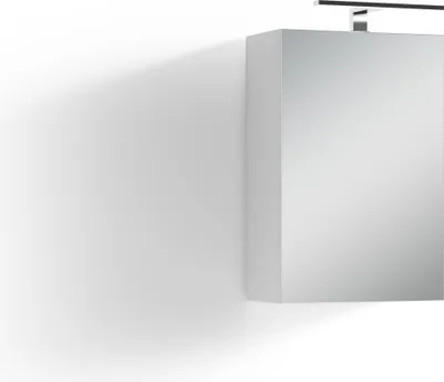 A mirrored cabinet with a light fixture above it, casting a shadow on a white wall.