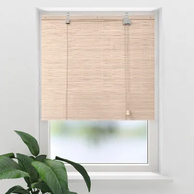 A bamboo roller blind is shown hanging in a window, with a plant in the foreground.