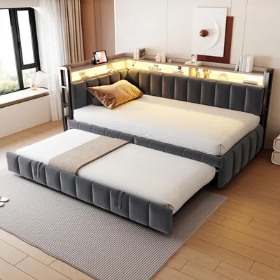 A modern bedroom or living room setting with a sofa bed and a pull-out bed.