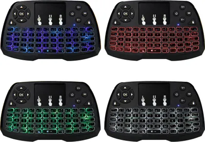 A collage of four backlit wireless keyboard and touchpad remote controls, each with a different color backlight.