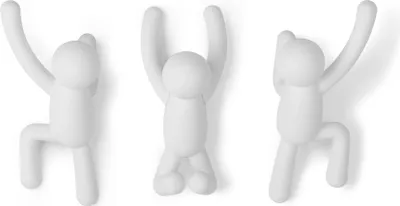Three white hook figures attached to a wall.