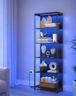 A tall, black metal bookshelf with wooden shelves, illuminated by blue LED lights, is placed in a room next to a window with sheer curtains. Decorative items are displayed on the shelves.