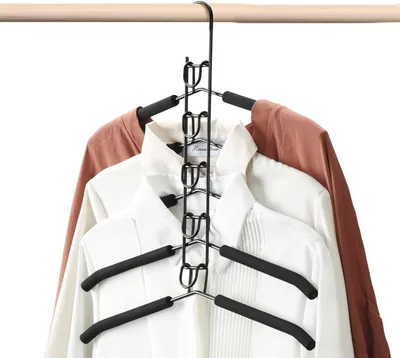 A black multi-tier hanger holding several shirts and a jacket on a clothes rack.