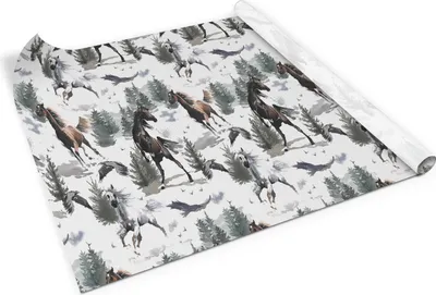 A roll of wrapping paper with a pattern of horses and trees.