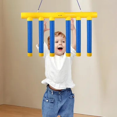 A baby is playing with a hanging toy.