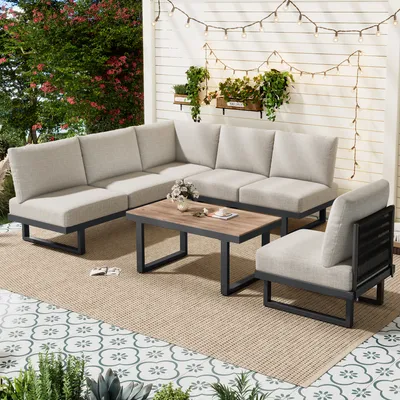 A 5-piece outdoor furniture set on a patio with string lights and plants.