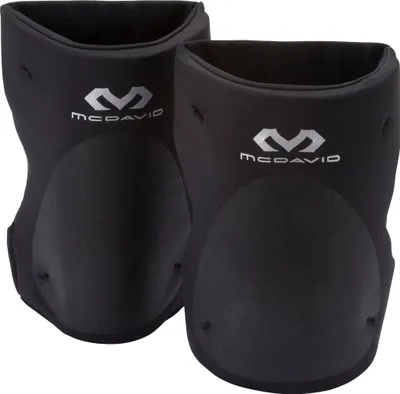 A pair of black McDavid knee pads are shown against a white background.