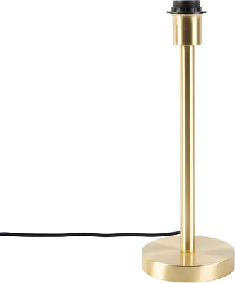 A brass table lamp base with a black cord on a white background.