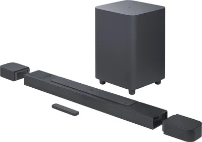 A JBL soundbar system with a subwoofer and two satellite speakers, arranged on a white background.