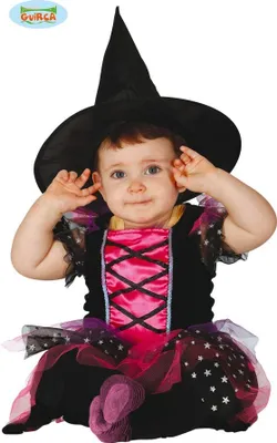 A baby wearing a witch costume, sitting down and looking at the camera.