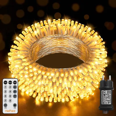 A coiled string of warm white LED lights with a remote control and power adapter.