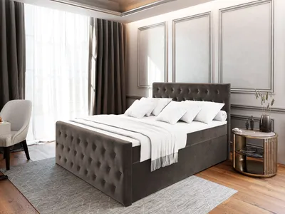 A bedroom scene with a bed, chair, and nightstand.